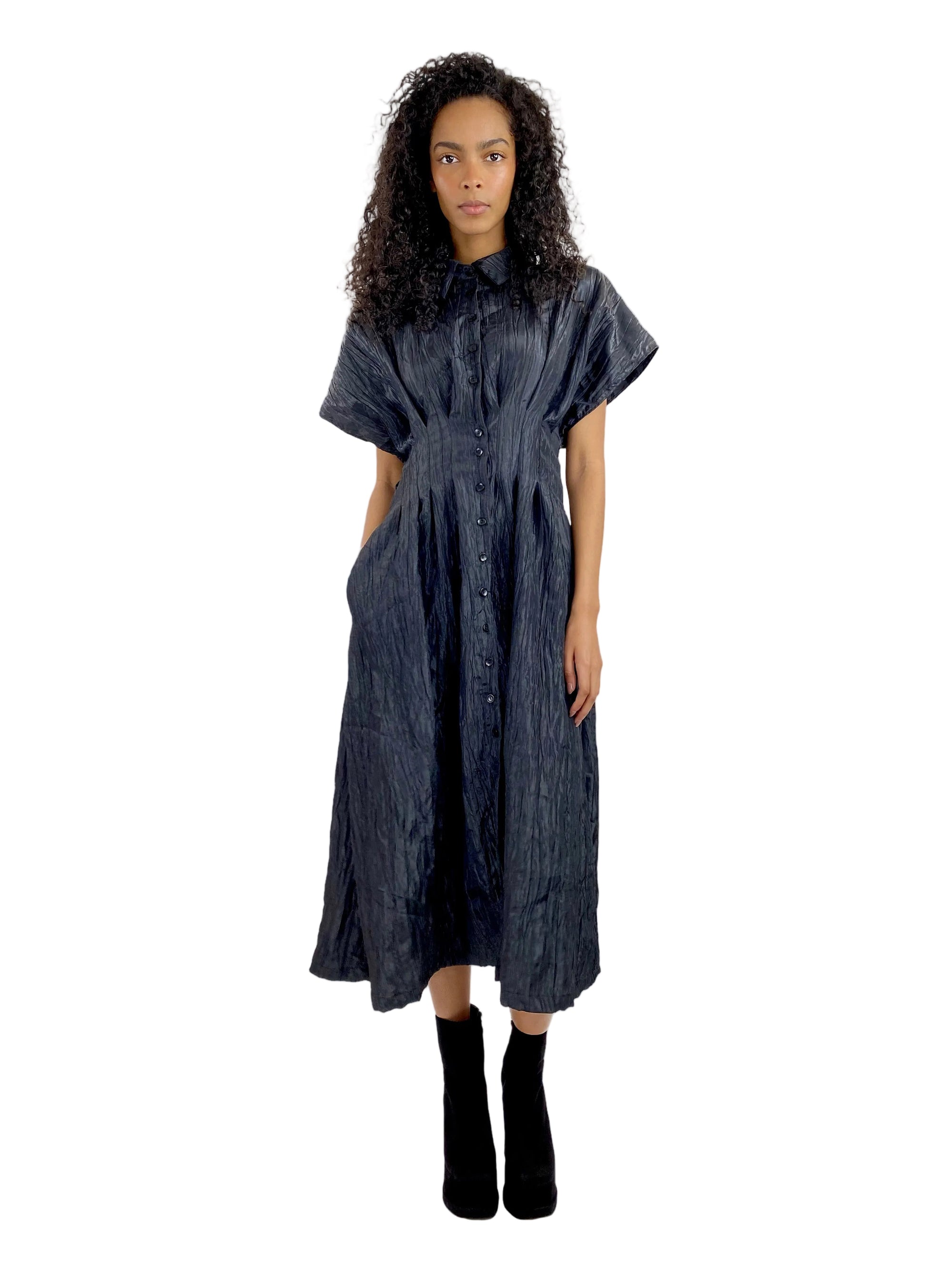 Woman wearing a dark denim dress on a white background