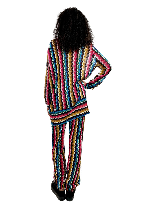 Person wearing a colorful striped outfit on a white background