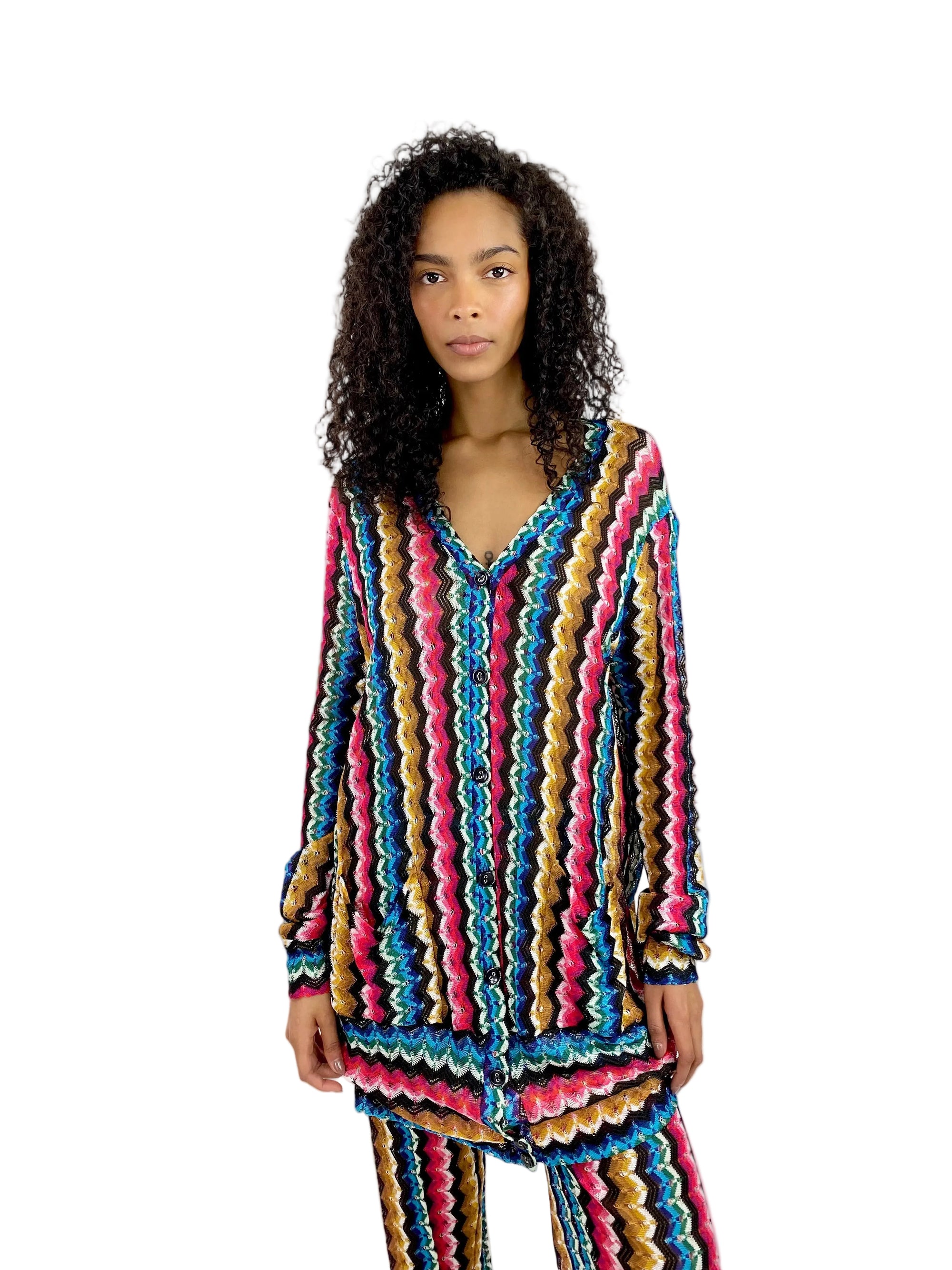 Woman wearing a colorful striped outfit on a white background