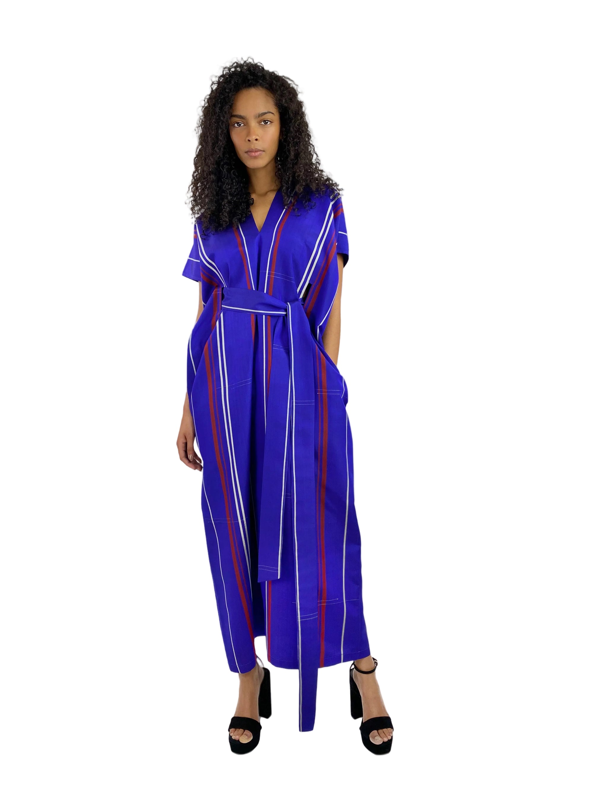 Woman wearing a blue and red striped jumpsuit on a white background