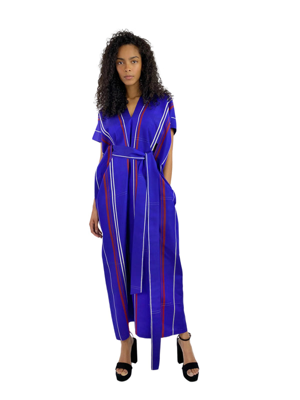 Woman wearing a blue and red striped jumpsuit on a white background