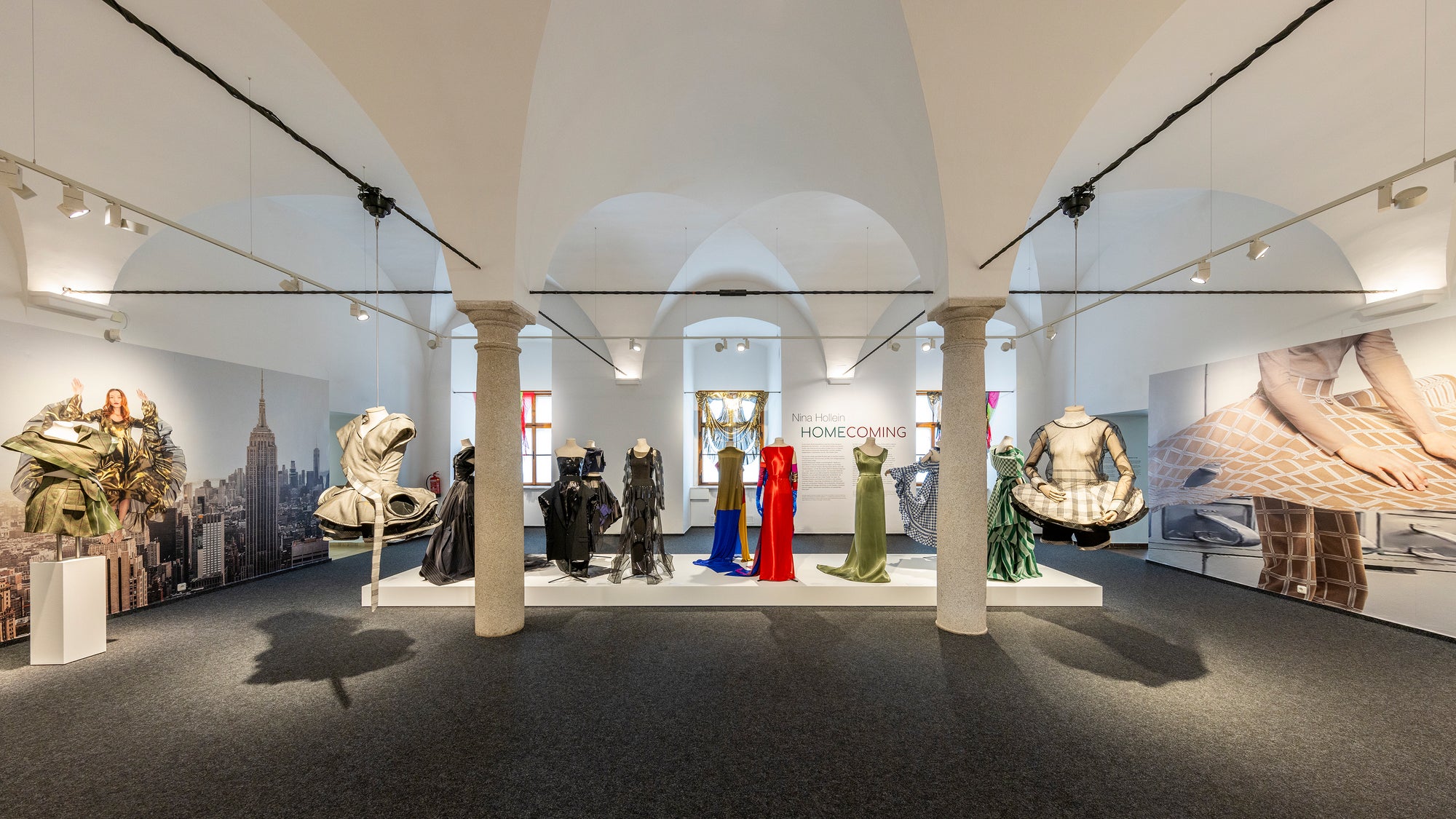 An expansive museum interior showcasing a variety of mannequins arranged throughout the large room.